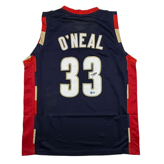 Back view of navy blue basketball jersey with red and gold trim displaying "O'NEAL" and number "33" in white and gold lettering.