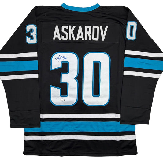 Back view of black Yaroslav Askarov San Jose hockey jersey number 30 with blue and white striping and signature.