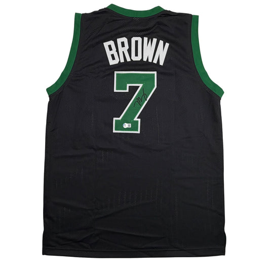 Back view of black basketball jersey with green trim displaying "BROWN" and number 7 with signature.