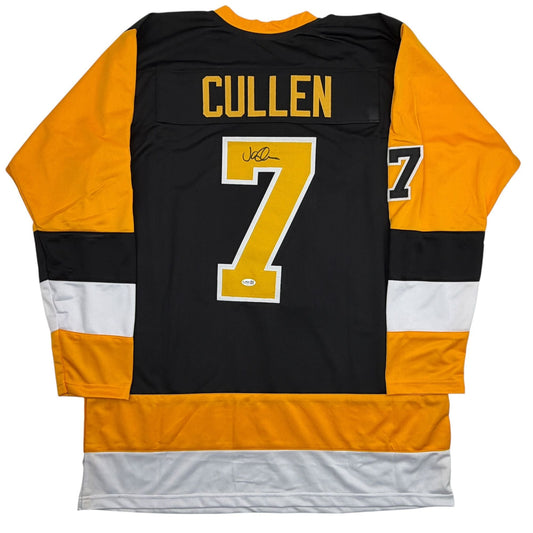 Back view of black and gold hockey jersey with "CULLEN" and number 7, signed in black ink, displayed flat.
