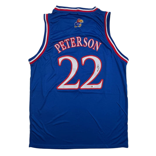 Blue Kansas Jayhawks basketball jersey number 22 Peterson displayed flat against white background, back view showing name and number.