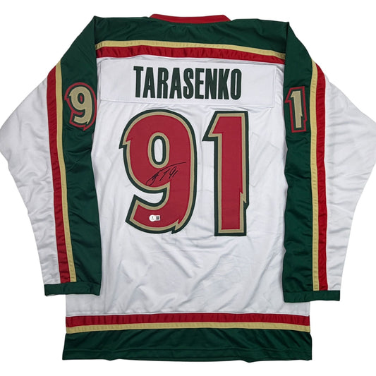Back view of white hockey jersey with green and red trim, displaying "TARASENKO" and number "91" in red with gold outline.