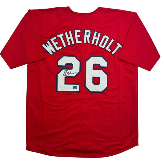 Red baseball jersey displayed flat showing back with "WETHERHOLT" name and number 26 in white with blue trim, signed.