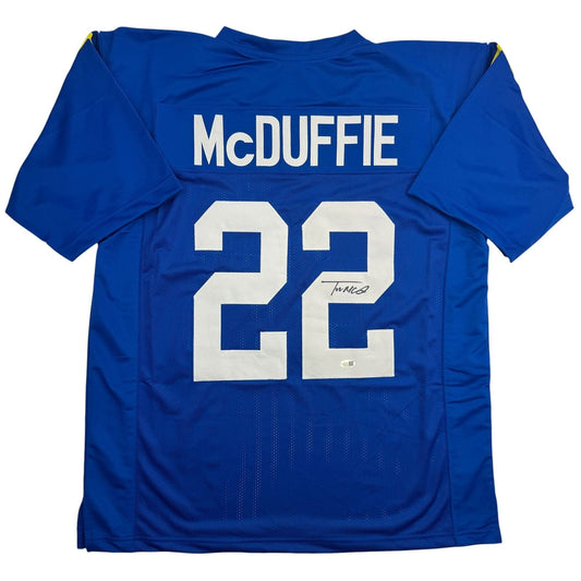 Blue football jersey displaying "McDUFFIE" and number "22" on back, signed in black ink.