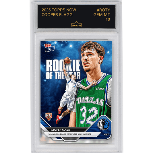 Graded trading card in clear plastic case showing Cooper Flagg in Dallas Mavericks green jersey with "Rookie of the Year" text on blue background.