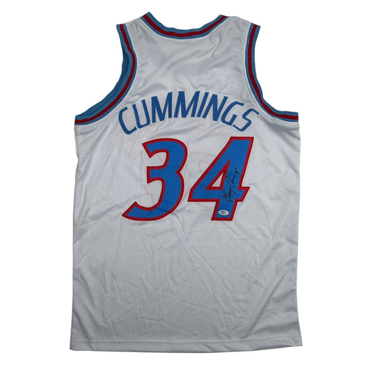 Back view of white basketball jersey with "CUMMINGS" and number "34" in red and blue, featuring an autograph.