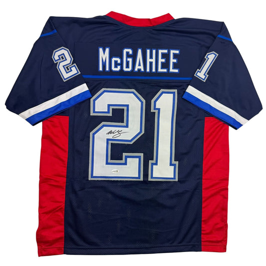 Back view of navy blue football jersey number 21 with McGahee name and signature, red side panels, white and blue trim.