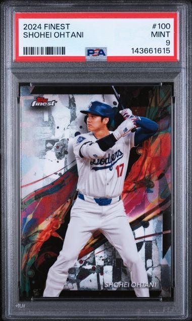 PSA-graded 2024 Topps Finest Shohei Ohtani baseball card #100 in protective case showing player in Dodgers uniform mid-swing.