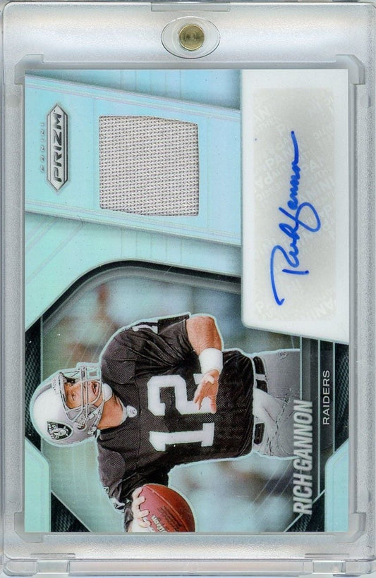 Front of football card featuring Rich Gannon in Raiders uniform with fabric patch swatch and blue autograph on turquoise background.