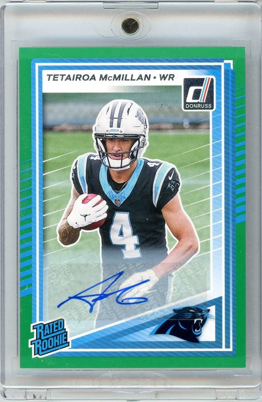 Front of 2025 Panini Donruss Tetairoa McMillan rookie card showing player in Panthers uniform with blue autograph on green-bordered card.
