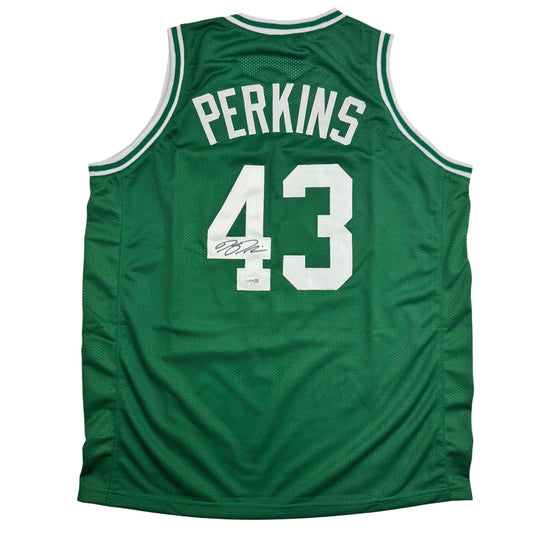 Back view of green Boston Celtics basketball jersey number 43 with "PERKINS" nameplate and autographed signature.
