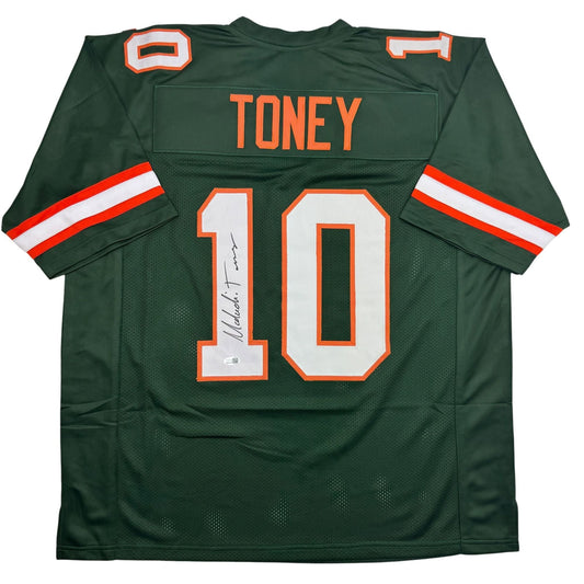Green college football jersey with orange and white number 10, TONEY nameplate, red-white striped sleeves, and autograph on front.