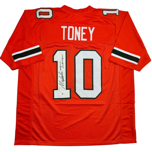 Red college football jersey number 10 with "TONEY" nameplate and autographed number, flat lay front view.