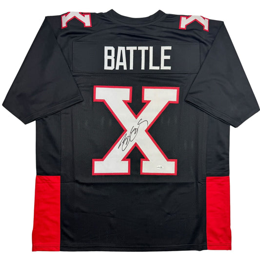 Black football jersey with red side panels, large red and white X logo, "BATTLE" text across chest, and signature on white X stripe, displayed flat against white background.