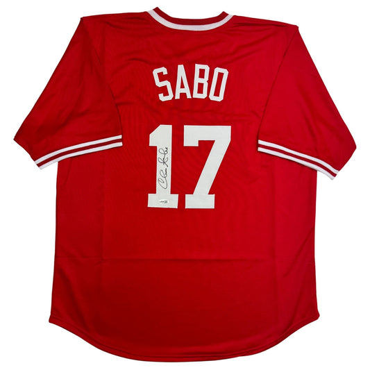Red Cincinnati Reds baseball jersey with white "SABO" name and "17" number on back, displaying autograph signature.