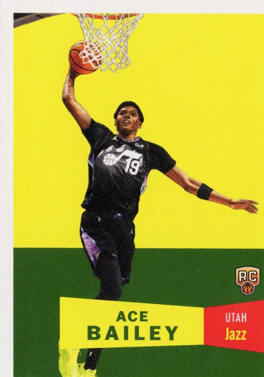 Ace Bailey wearing black Utah Jazz jersey number 19 dunks basketball against yellow and green background on rookie card.