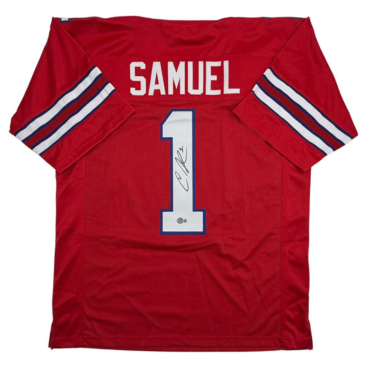 Red football jersey with "SAMUEL" printed across shoulders and large white number "1" with signature on chest, displayed flat against white background.