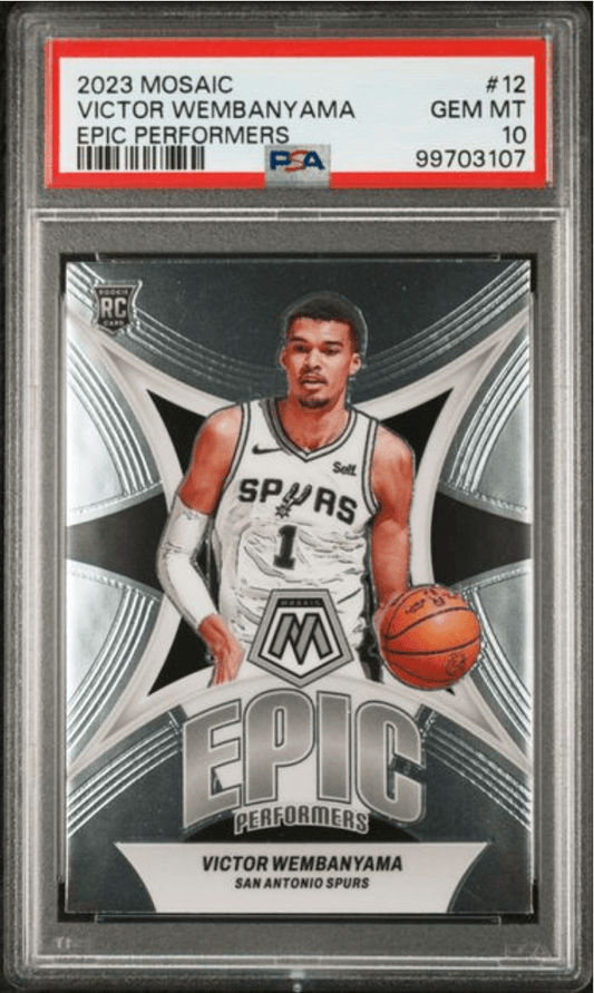 PSA-graded trading card showing Victor Wembanyama in San Antonio Spurs white jersey holding basketball against geometric black and silver background.