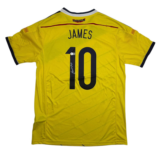 Back view of yellow Colombia soccer jersey with "JAMES" and number "10" printed in black, featuring autographed signature on the number.