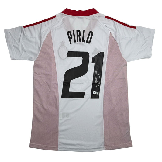 Back view of white and mauve AC Milan jersey with "PIRLO 21" and autographed signature on black number patch.