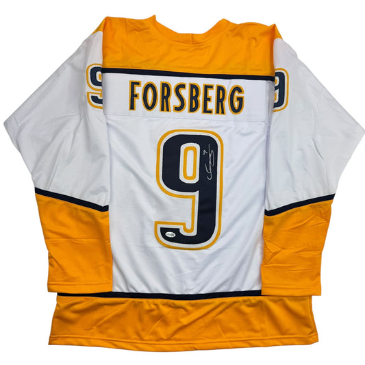 Back view of white and gold Nashville Predators hockey jersey number 9 with "FORSBERG" nameplate and autograph.