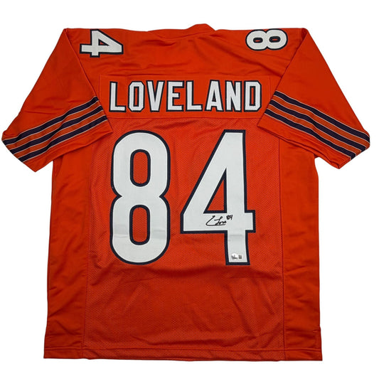 Back view of red Loveland football jersey number 84 with white numerals and navy stripe detailing on sleeves.