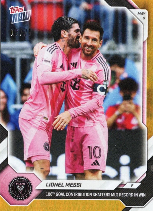 Two Inter Miami players in pink uniforms embrace on field, with Messi wearing number 10, photographed during a match with crowd visible in blurred background.