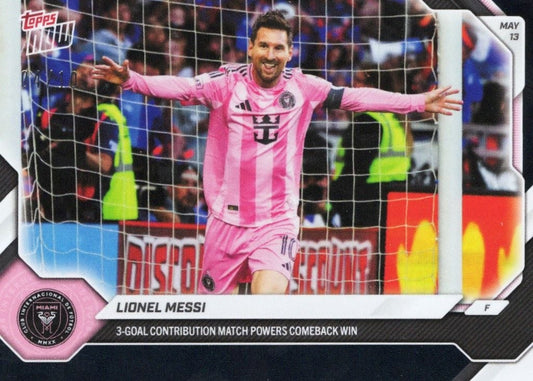 Lionel Messi in pink Inter Miami jersey celebrating with arms spread wide by goal net, Topps Now card front with black foil border and May 13 date.