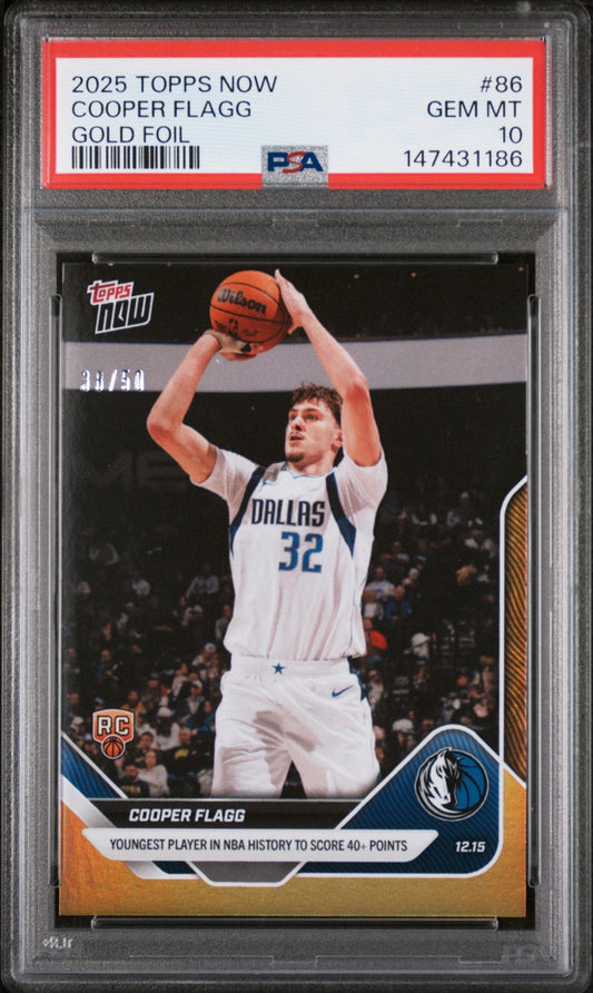 PSA-graded trading card in clear plastic case showing Cooper Flagg in white Dallas Mavericks uniform shooting basketball, with red label and gold foil designation visible.