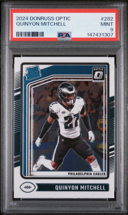 PSA graded rookie card in clear plastic case showing Quinyon Mitchell in Philadelphia Eagles uniform on blue background with red grading label.