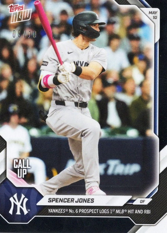 Spencer Jones batting in gray Yankees uniform with pink bat, mid-swing during game, card shows "09/10" and "MAY 10" date marking.