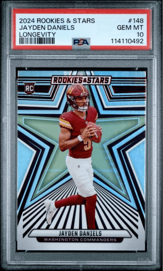 PSA-graded Jayden Daniels rookie card in plastic case showing front with player in red Commanders uniform against blue geometric design.