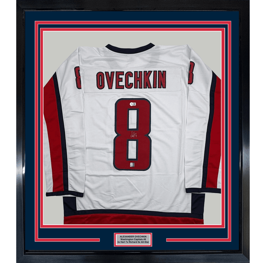 White Washington Capitals hockey jersey number 8 with "OVECHKIN" nameplate, signed, displayed in framed presentation with red and navy borders.