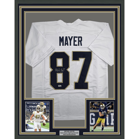 White Notre Dame football jersey #87 signed by Michael Mayer, framed with photos and nameplate on dark background.