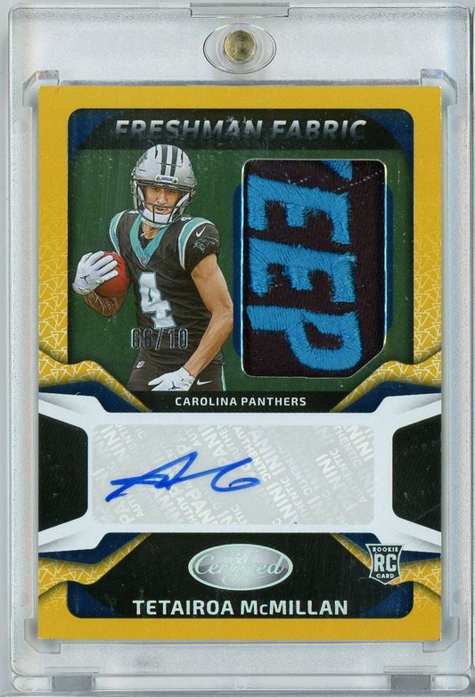 Front of graded football card showing Panthers player in dark jersey holding football, blue fabric swatch, autograph, and yellow border in clear case.
