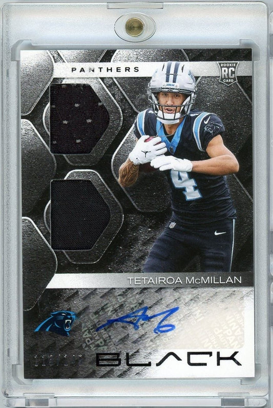 Front of graded rookie card showing McMillan in Panthers uniform holding football, with autograph and jersey swatch visible, black and silver design.