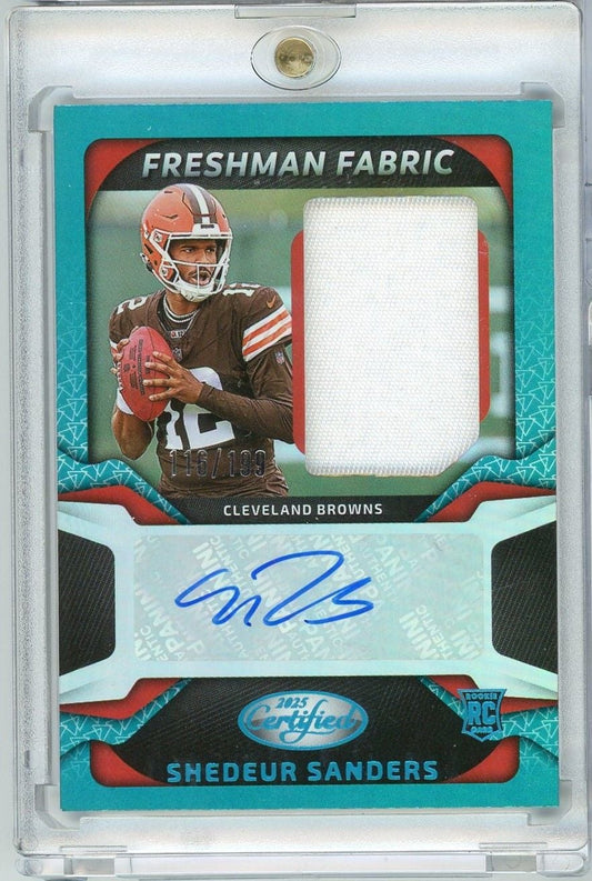 Front of graded rookie card showing Shedeur Sanders in Cleveland Browns uniform with fabric swatch and blue autograph on turquoise background.