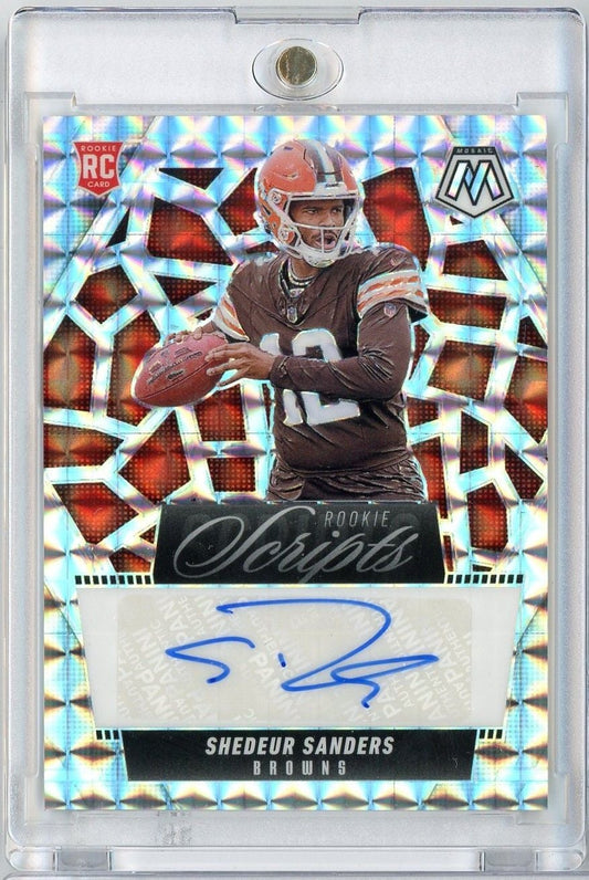 Rookie Scripts autographed football card of Shedeur Sanders in Browns uniform against holographic geometric background, signed in blue ink.