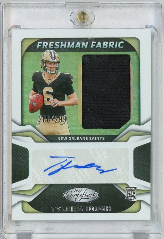 Front of graded rookie card showing Tyler Shough in Saints uniform with black fabric swatch and blue autograph, numbered 288/299.