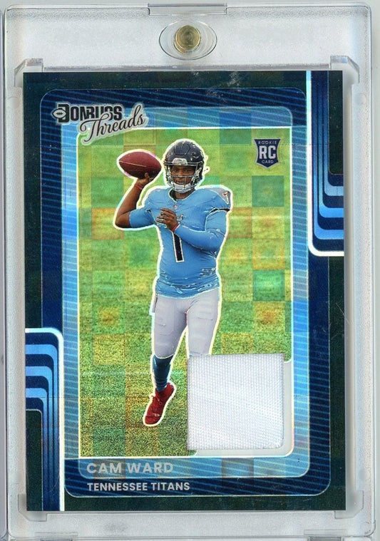 Front of graded rookie card showing Cam Ward in blue Titans jersey throwing football, with white fabric relic swatch visible below player image.