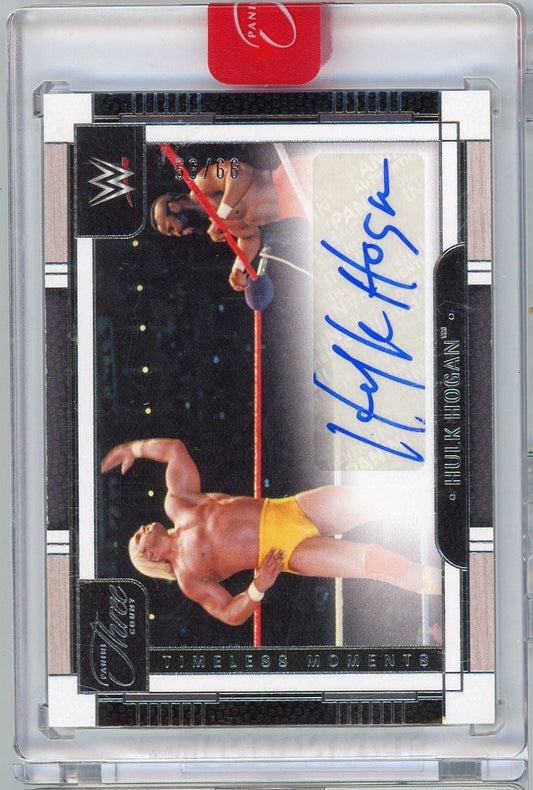 Front of signed wrestling card showing Hulk Hogan in yellow trunks with red rope, blue autograph, numbered 99/66, in clear plastic case with red tab.