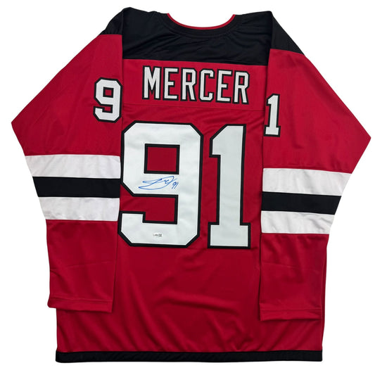 Red, white, and black hockey jersey with "MERCER" and number "91" on back, featuring an autographed signature on the white number panel.