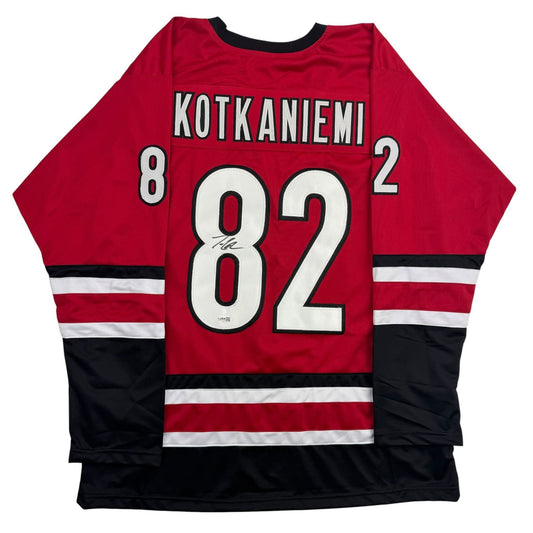 Back view of red and black hockey jersey with white "KOTKANIEMI 82" lettering and visible autograph on number eight.