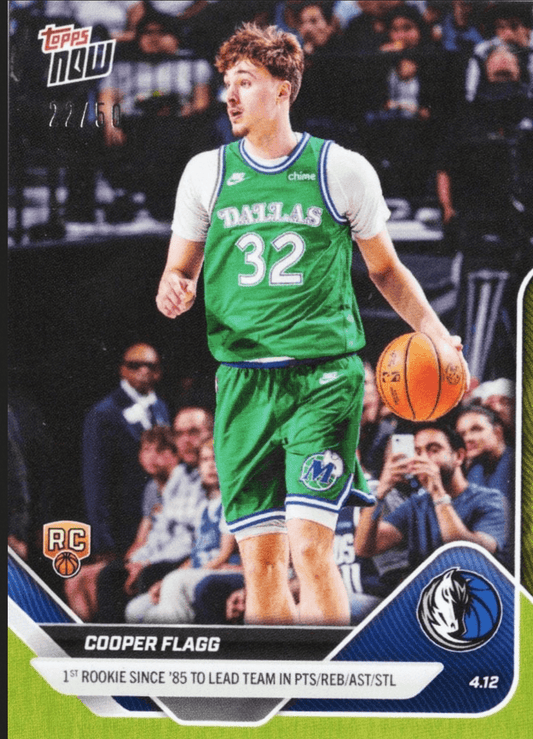 Cooper Flagg wearing green Dallas Mavericks #32 jersey dribbling basketball during game with crowd background.