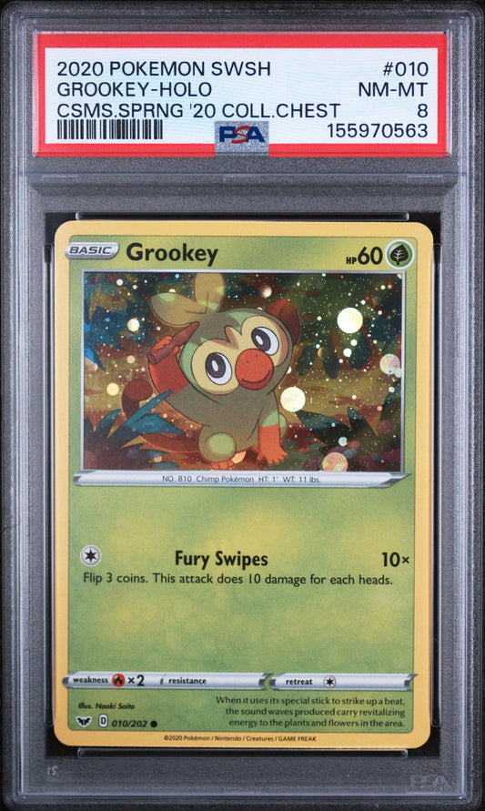PSA-graded Grookey Pokémon card in clear case showing green card with red label and holographic Grookey illustration.