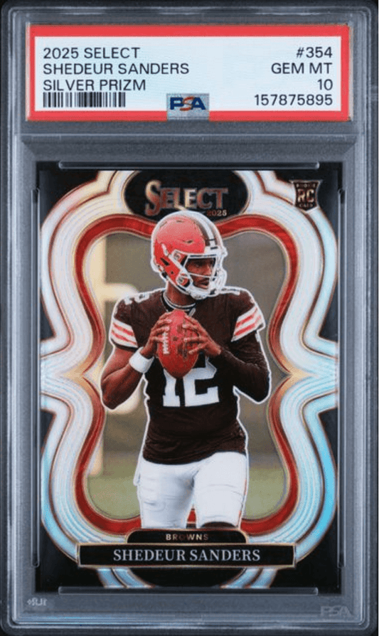 PSA-graded trading card in clear case showing Shedeur Sanders in Browns uniform holding football against red and blue wave-patterned background.
