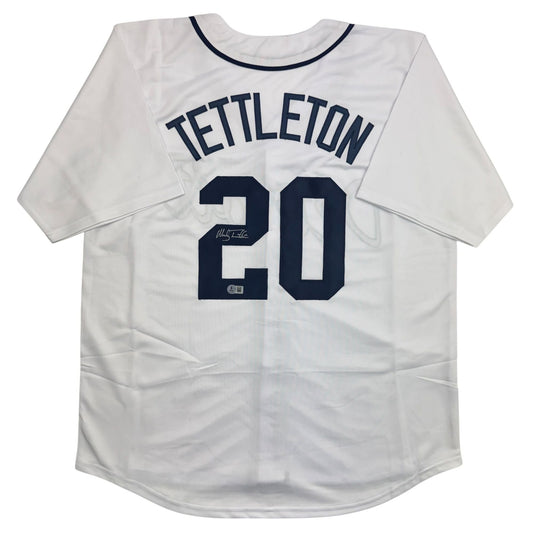 White baseball jersey with navy "TETTLETON" and number "20" on back, autographed.