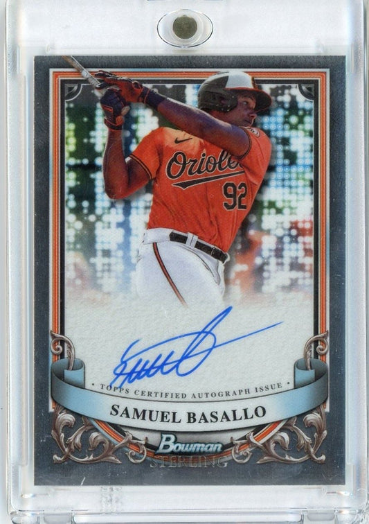 2024 Bowman Sterling Samuel Basallo autographed rookie baseball card showing player in red Orioles uniform mid-swing.