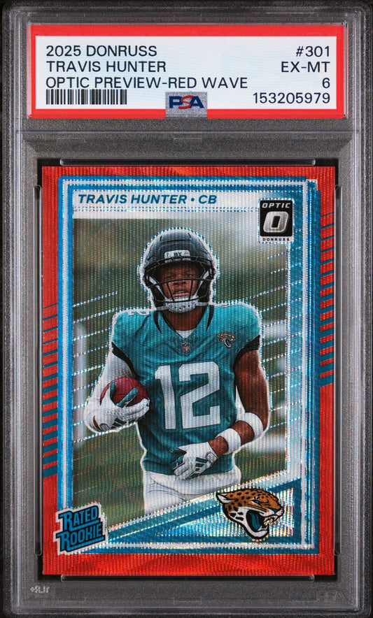 Front view of graded rookie football card in clear case showing Travis Hunter in teal Jaguars uniform with red wave design border.