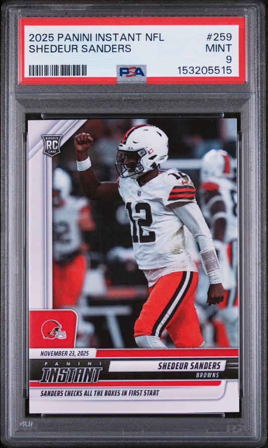 PSA graded rookie card in clear case showing Shedeur Sanders in white and red Browns uniform with fist raised, card number 259 visible on red label.